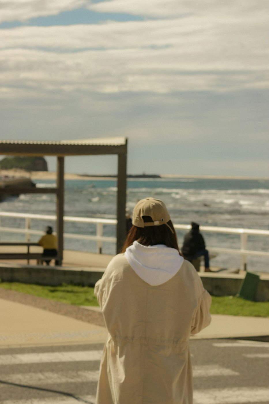 A visitor looking toward the ocean from Newcastle's waterfront