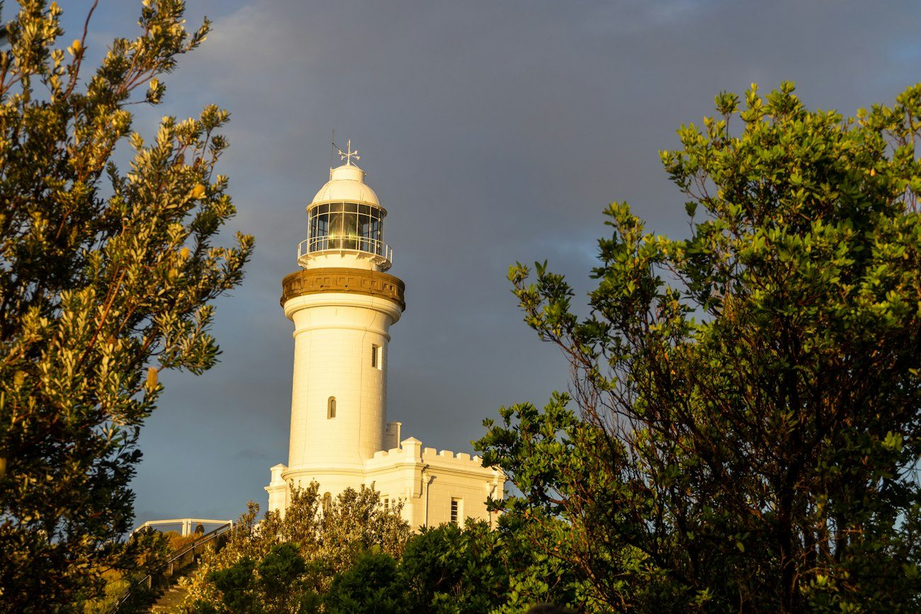 Cape Byron Lighthouse rising above coastal trees