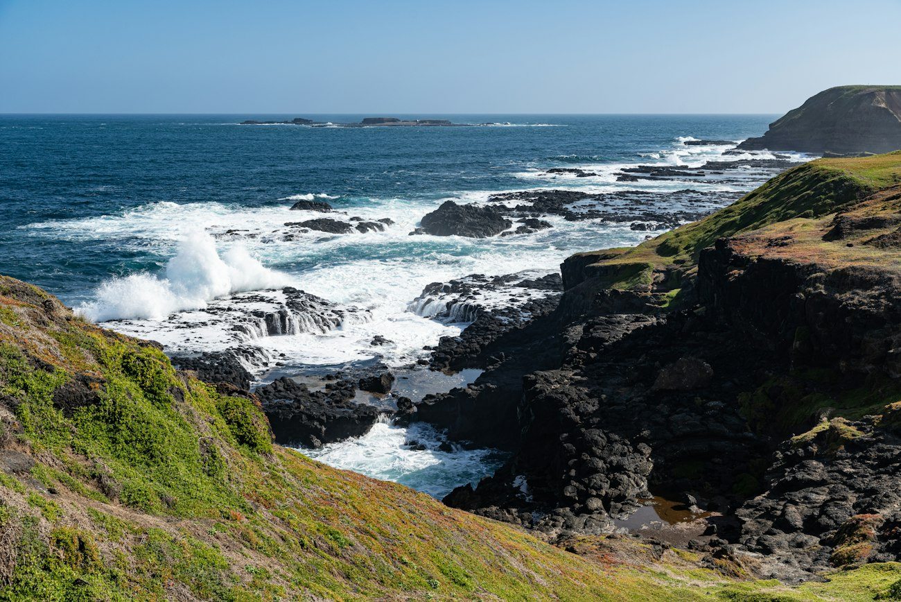 Waves breaking against Phillip Island's rocky coast