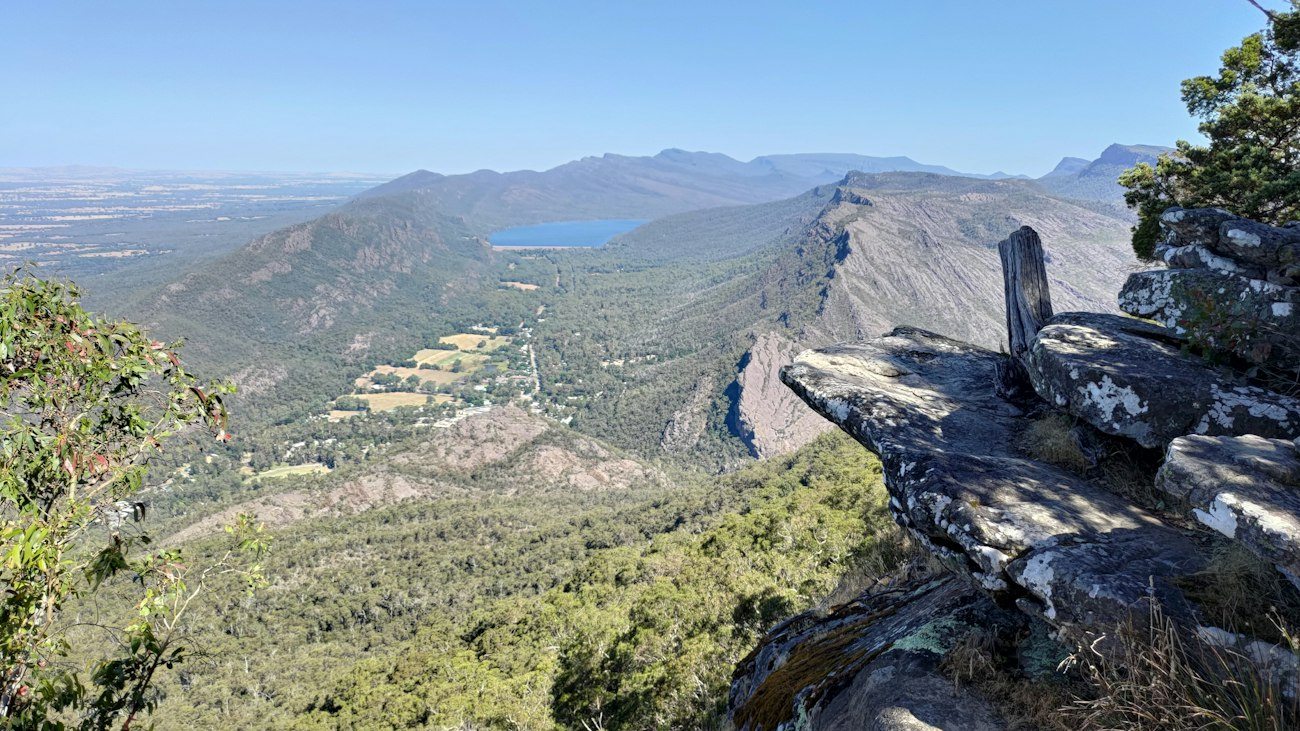 A rocky lookout above forested Grampians ranges