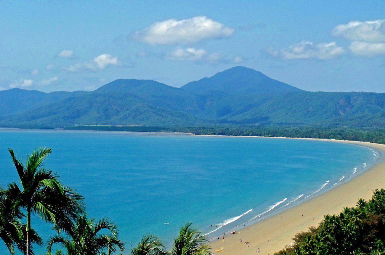 Four Mile Beach curving toward the hills at Port Douglas