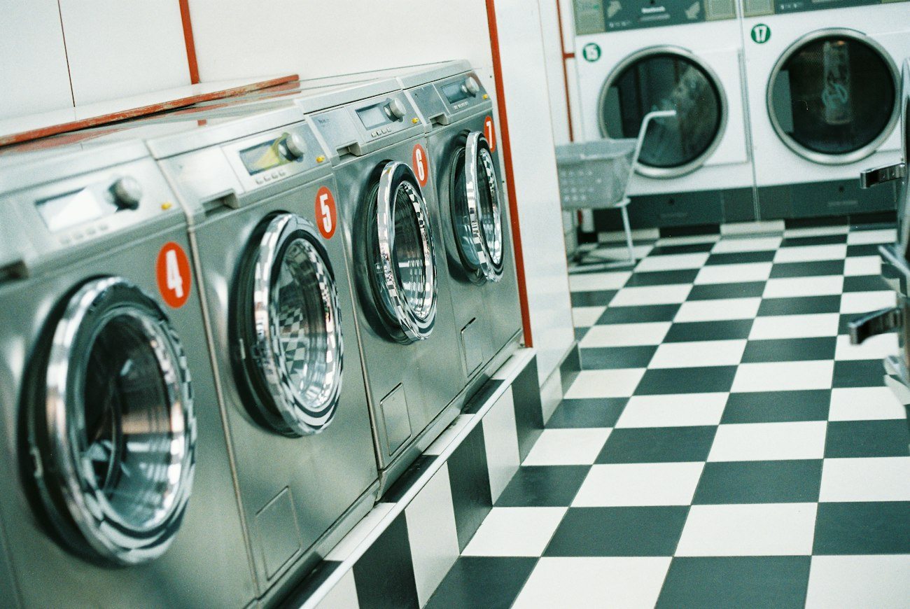 A row of washing machines inside a laundromat